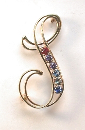 Open S monogram pin with 6 gemstones